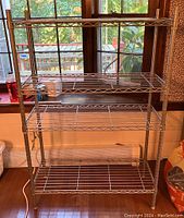 Front view of 4-tier Sensible Shelving NSF indoor unit in chrome finish showing four wire shelves and tubular legs.