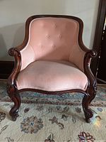 Front view of the antique Victorian pink velvet parlour chair showing full upholstery and wooden frame shape.