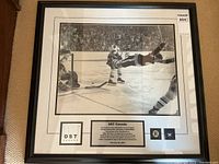 Full front view of framed photograph and plaque