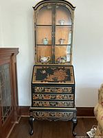 Full frontal view of cabinet desk showing upper glass display doors, drop-front desk and base drawers