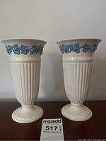 Pair of cream Etruria Wedgwood vases on a table showing full height and shape