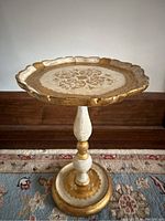 Full front view of the entire table showing shape, finish, and size relation to floor molding.