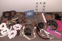 Photo showing all hair accessories spread out with clear visibility of different types including claws, scrunchies, combs, and headbands plus panoramic view of flower picture frames.