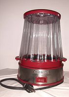 Front view of the Cuisinart EasyPop popcorn maker showing the red and stainless steel base with ON/OFF switch and attached clear plastic cover.