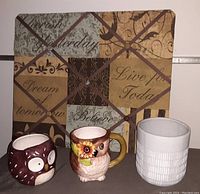 Two owl mugs, light gray ceramic planter, and tufted message photo memo board with inspirational text.