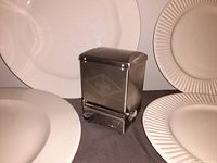 Metal Coca Cola toothpick dispenser with visible embossed logo and push-lever.