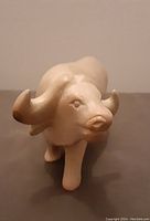 Front view showing detailed face and horns of the carved soapstone water buffalo figurine.