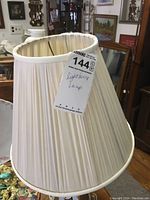 Front view of the pleated white fabric lamp shade with price tag