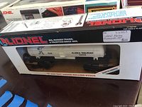 Photo of Lionel O Gauge Alaska Railroad Tanker Car #3822 in original box with visible branding and tank markings.