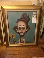 Front view of framed painting showing tramp figure and gilt frame