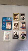 Image showing a group of baseball and hockey cards laid out, including Babe Ruth cards and other baseball cards, plus a blue package for hockey cards dated 1991-92.