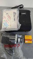 Canon Auto Zoom 518 SV Super 8 camera with carrying case, user manuals in plastic wrapper, and unopened Kodachrome 40 film cartridge.