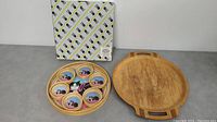 Photo showing cat design bamboo coaster set in round holder, boxed, next to wooden bentwood tray with handles