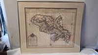 Full view of framed map of Martinique with metal frame and glass front
