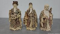 Front view of the three Fu Lu Shou Chinese wise men resin figurines showing their size and detailed patterns on their robes.