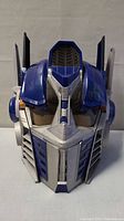 Front view of the blue and silver Optimus Prime helmet showing detailed facial design and wear.