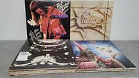 Photo of four LP album covers including Pat Travers Band, Chicago, Jethro Tull, and Styx.