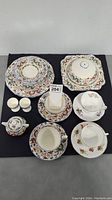 Full lot showing an assortment of Ducal Crown Ware and Royal Albert cups, saucers, plates, egg cups, and a small bowl.