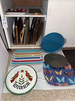 Variety of trays and baking pans arranged for photo showing materials and condition.