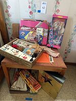 Overview of lot items including boxed and loose dolls, accessories on bench