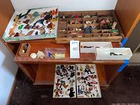 Overview of shadowbox on stand with multiple trays and figure display