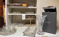 Photo of various clear glass plates and bowls on a shelf including WaltherGlas items and a rectangular serving plate.