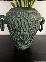 Close-up front view of the large vase showing the detailed brutalist texture and side loop handles.