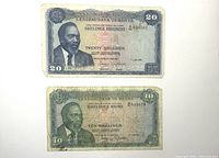 Front view of two Kenyan bank notes, 20 Shillings on top and 10 Shillings below, showing portraits and text.