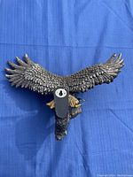 Back view of eagle sculpture showing mounting bracket and part of branch base.