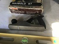 Mastercraft No. 3 smooth plane placed next to its original box with visible wear, laying on a flat surface.