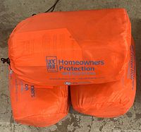 Orange colored bags with Homeowners Protection, FB Systems branding, showing item branding and condition.