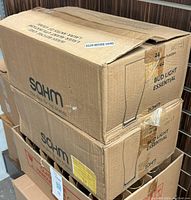 Two stacked cardboard boxes labeled SOHM and containing 24 glasses each, marked as Bud Light Essential licensed glasses of 16 oz capacity.