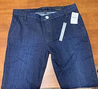 Close-up of one pair of new Nordstrom STS jeans, showing front design, waistband and tag