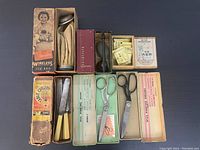 Top-down view showing assorted antique items including wireless ice bag, cutlery boxes, sewing supplies, scissors, and ginseng powder.