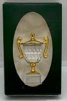 Clear faceted crystal trophy figurine with gold-colored handles and base inside original box window.