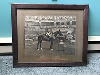 Framed vintage photo showing the full image of the royal figure on horseback in a stadium setting.