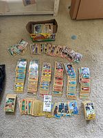 Box and several stacks of vintage baseball cards laid out on the floor