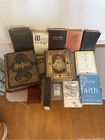 Overview of assorted books on folding table showing back row and front row