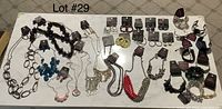 Full display of 10 pairs pierced earrings, 10 bracelets, and 10 necklaces with matching earrings on a table labeled Lot #29