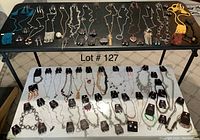 Wide overview showing two tables with all necklaces, matching earring sets, loose earrings, bracelets and ring