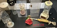 Overview of lot showing 4 clear acrylic display cases, Dormeyer blender, electric carver, two figurines including an angel and dancing woman, and two clear containers
