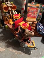 Dinosaur-themed toy vehicle with orange tube parts and black sails
