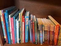 Bookshelves with multiple children's books showing colorful spines and titles mostly related to animals and early learning