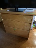 Top front view showing wooden cabinet with TV on top (TV not included)