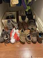 Photo showing eight pairs of men's shoes, assorted styles and colors, size 9, worn condition.