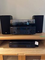 Full system overview with turntable on top shelf, receiver and speakers