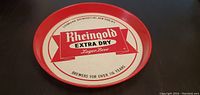 Front of round serving tray showing Rheingold Extra Dry Lager Beer logo and text.