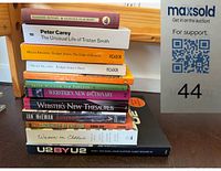 Stack of 12 books showing spines with titles and authors visible, confirming the content of the lot.