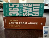 Side view of the stacked books showing titles and colors of spines.