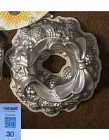 Top view of the detailed holiday wreath shaped bundt pan displaying pine cone and bow details